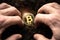 Bitcoin hold concept. Cryptocurrency stored in the ground - saving symbol. A man digs up hidden bitcoins