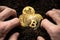 Bitcoin hold concept. Cryptocurrency stored in the ground - saving symbol. A man digs up hidden bitcoins