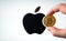 Bitcoin infront of apple logo on white background. To simulate the future of crypto currency,