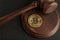 Bitcoin and judge gavel. Cryptocurrency legislation. Close up. Violation of law