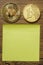 Bitcoin and one euro coin on a wooden table and empty yellow memo note. Money and finance concept. Financial decision on future