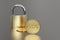 Bitcoin and padlock over a neutral grey background