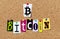 Bitcoin symbol and word blockchain on cork notice board