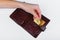 Bitcoin theft concept. A hand steals bitcoin from a wallet. Place for writing