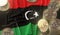 Bitcoin tokens and flag of Libya. Cryptocurrency related 3D rendering