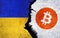 Bitcoin and Ukraine flag on a wall with a crack