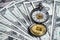 Bitcoin and vintage pocket watch on money dollar banknotes using