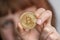 Bitcoin in woman hand. Growth or collapse cryptocurrency value