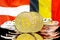 Bitcoins on Belgium and Austria flag background