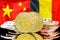 Bitcoins on Belgium and China flag background