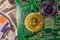 Bitcoins and circuit board on the one hundred dollar bills