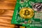 Bitcoins and circuit board on a wooden table