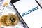 Bitcoins, dollars with Poloniex logo on the screen smartphone