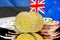 Bitcoins on Estonia and New Zealand flag background