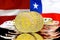 Bitcoins on Latvia and Chile flag background