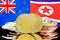 Bitcoins on New Zealand and North Korea flag background