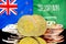 Bitcoins on New Zealand and Saudi Arabia flag background