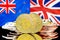 Bitcoins on New Zealand and United Kingdom flag background