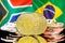 Bitcoins on South Africa and Brazil flag background