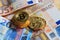Bitcoins stack on euro banknotes background
