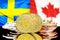 Bitcoins on Sweden and Canada flag background