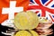 Bitcoins on Switzerland and UK flag background