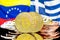 Bitcoins on Venezuela and Greece flag background