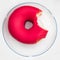 Bited Donut on a plate on colorful blue wooden background. Donut for bakery menu. Flat lay