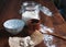 Bits of yeast on paper with containers and ingredients on a wooden base for making sourdough. Bakery concept