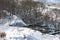 The Bitsa river in the Moscow region flows along a busy highway, trees and snow along the banks of the river, winter background