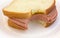 Bitten bologna sandwich on paper plate