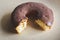 Bitten chocolate donut filtered. Homemade donut toned image. Fresh bakery. Sweet round cake glazed with chocolate.