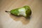 Bitten pear on a wooden table