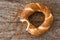 Bitten Turkish bagel simit on wooden background