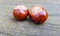 Bitter chestnuts resting on a smooth stone with a blurred background to put texts. Bitter chestnuts are the seed of Aesculus