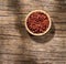 Bixa Orellana - annatto organic seeds in the wooden bowl