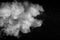 Bizarre forms of white powder explosion cloud against black background.White dust particles splash