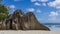 A bizarre granite rock on the sandy beach of Source d`Argent