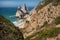 Bizarre rocks at Praia Da Ursa Beach, Sintra, Portugal. Towering cliffs and Atlantic ocean waves near famous Cabo Da