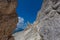 Bizarre shaped rocky pinnacle at the foots of rocky wall, Dolomites, Italy