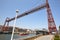 Bizkaia red iron hanging bridge and Nervion river. Euskadi