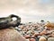 Bizzare stones on costline, the stony beach ends in smooth water of blurred ocean.