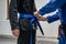 BJJ brazilian jui jutsu belt promotion close up on hands of unknown instructor black belt professor tie up blue belt on waist of