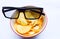 Black 3D glasses on fried potato isolated