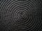Black abstract woven surface with spiral circles