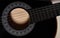 Black acoustic guitar soundhole closeup