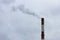 black acrid smoke from an industrial large chimney