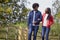 Black adult couple talking and walking arm in arm in the countryside