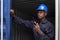 Black african amarican man worker working control loading freight containers at commercial shipping dock. cargo freight dock and