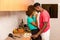 Black African American couple preparing food in the kitchen